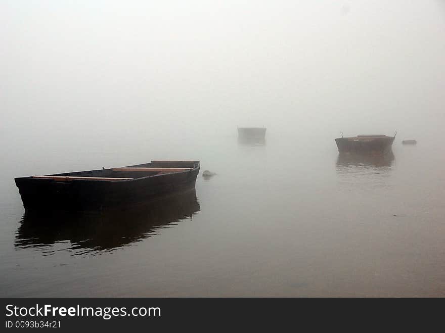 Misty rivershore at Duna river, late autumn. Not a sound heard except the small waves coused by boats. A bit mistical mood. Misty rivershore at Duna river, late autumn. Not a sound heard except the small waves coused by boats. A bit mistical mood.