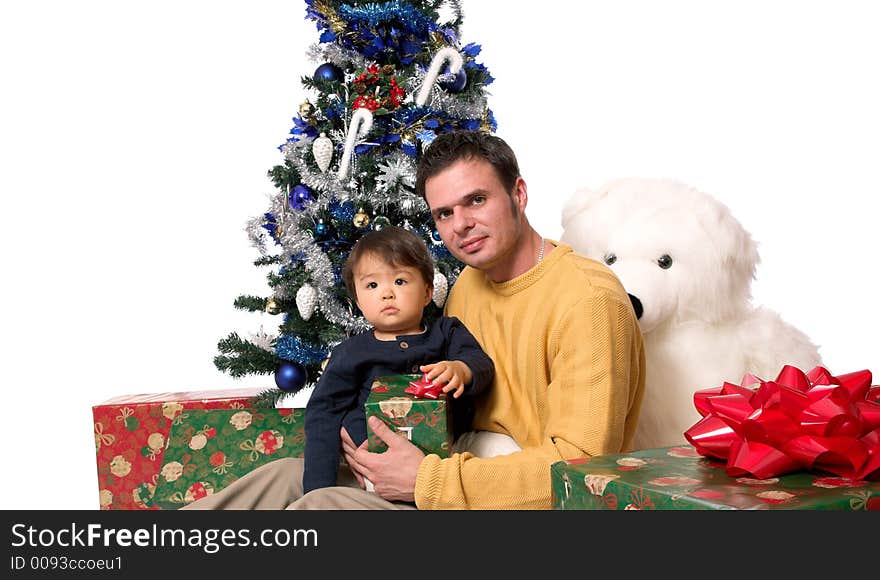 Father and son under the christmas tree, opening presents. Father and son under the christmas tree, opening presents