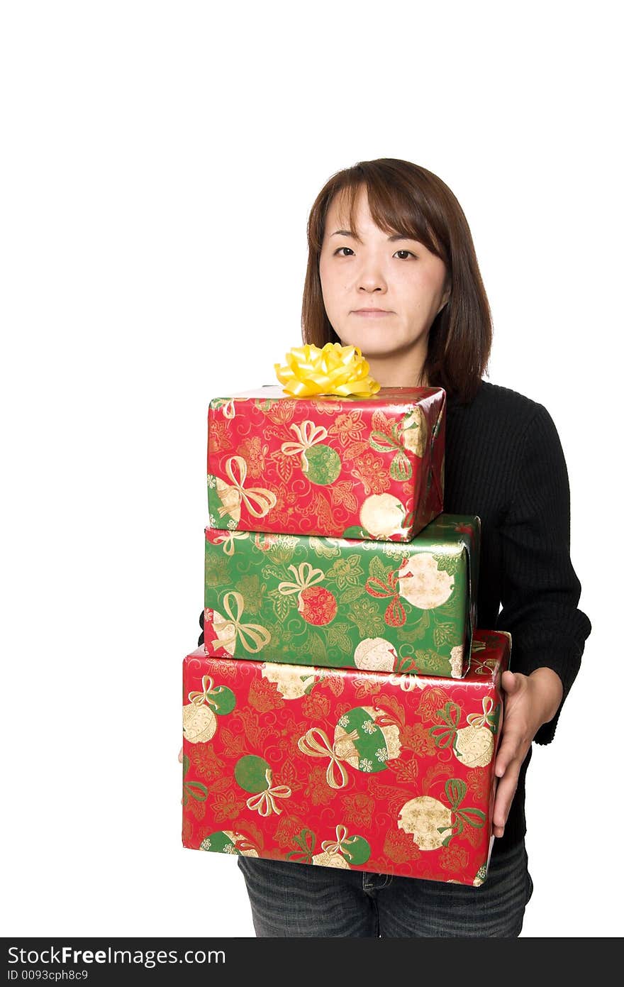 A young asian girl carrying  stack of christmas presents. A young asian girl carrying  stack of christmas presents