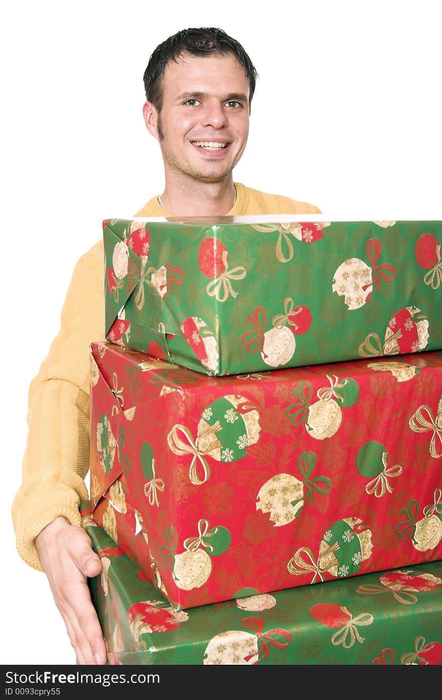 A young handsome guy carrying a  stack of christmas presents. A young handsome guy carrying a  stack of christmas presents