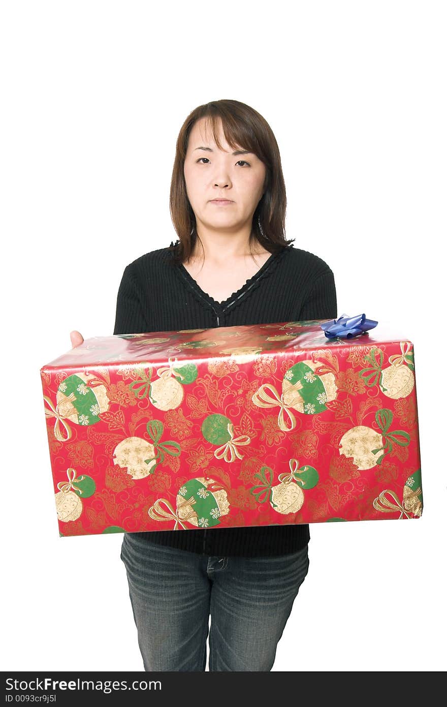 A young asian girl carrying a christmas present. A young asian girl carrying a christmas present