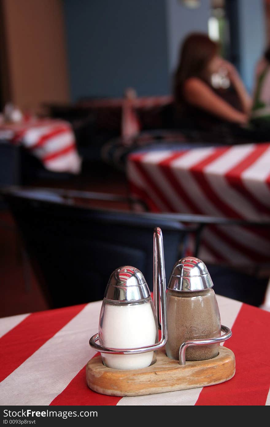 Interior of a restaurant with salt and pepper on the first side