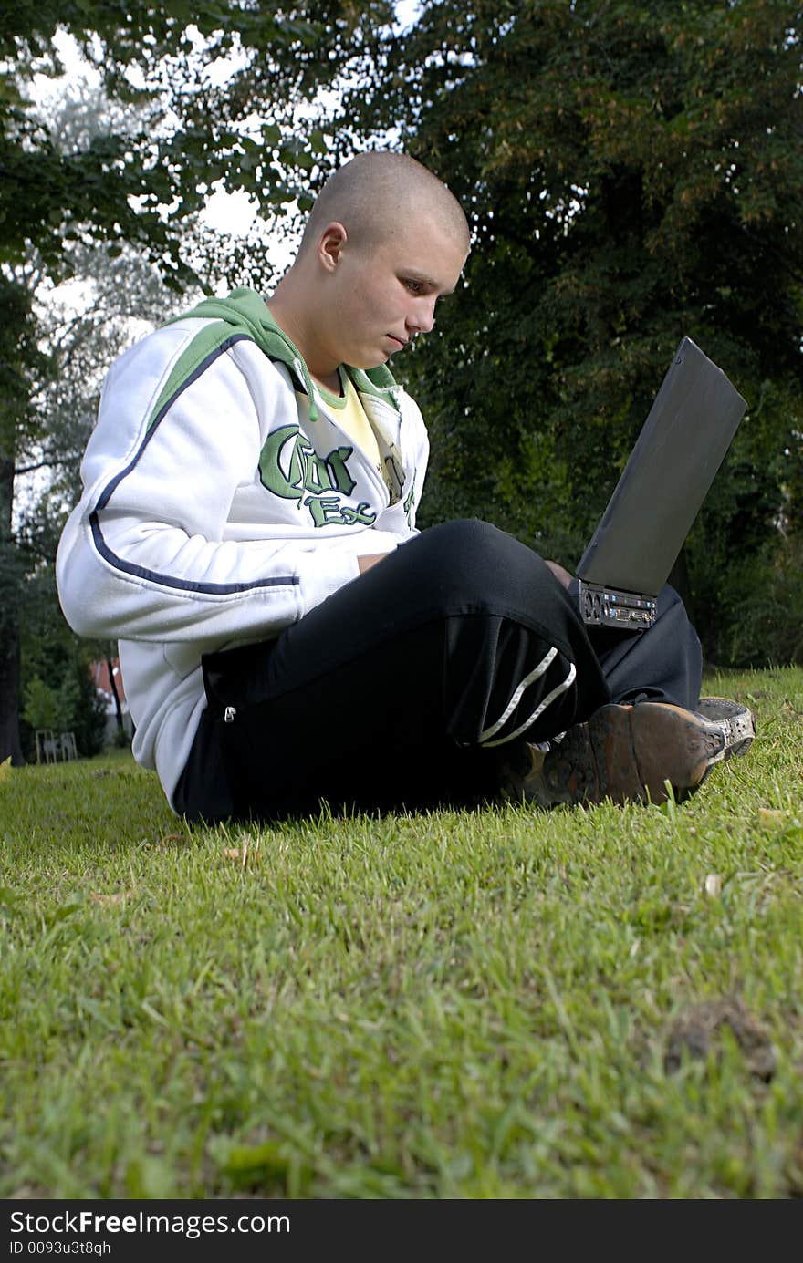 Boy with notebook in park