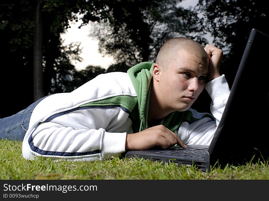 Boy with notebook in park