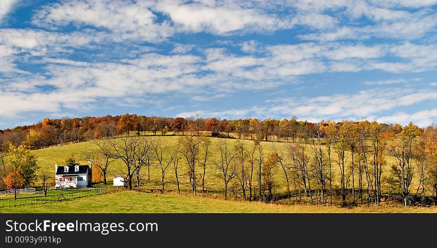 Looking down at a farm house in late afternoon. Looking down at a farm house in late afternoon