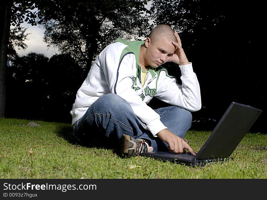 Boy with notebook in park