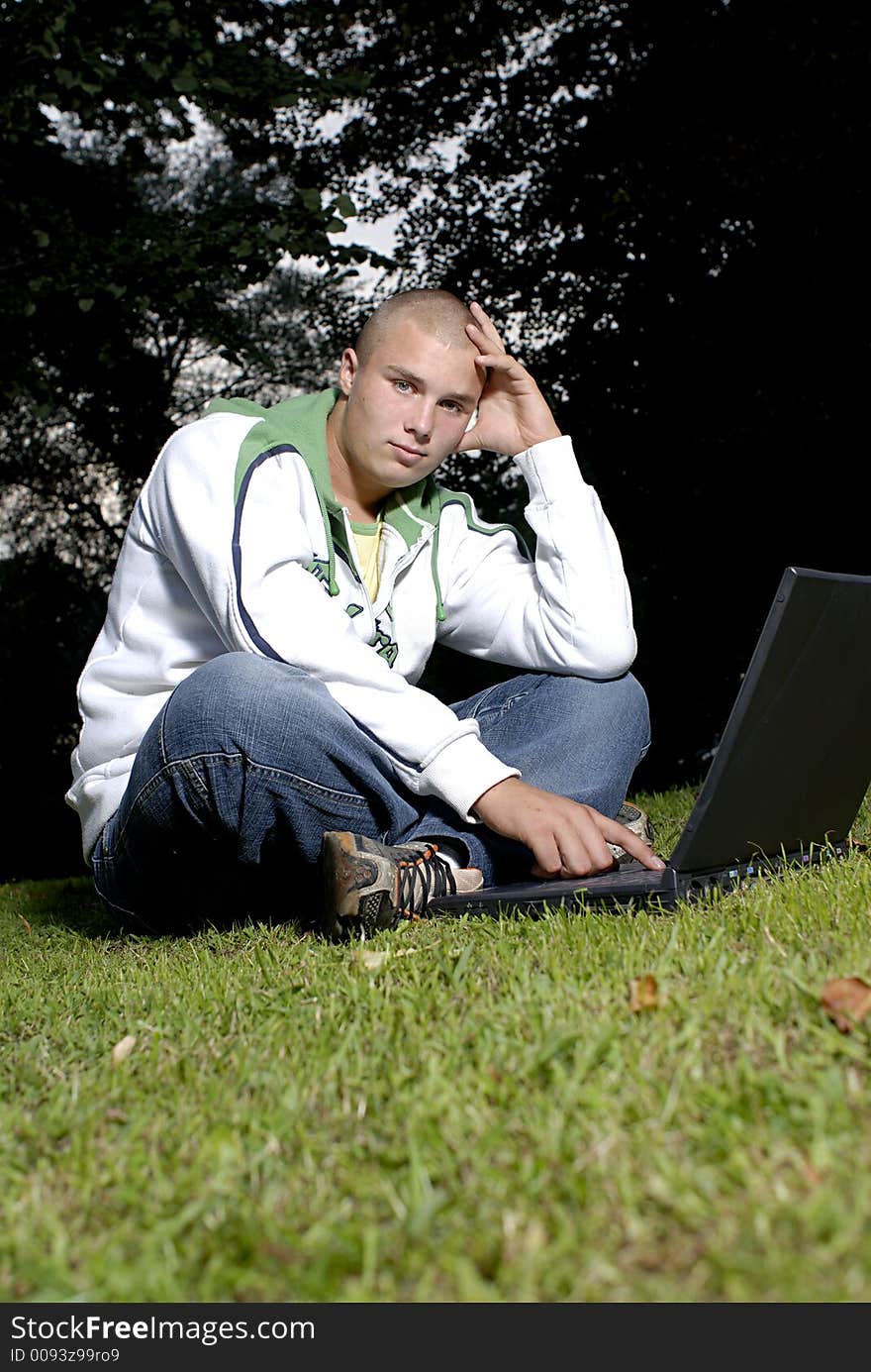 Boy with notebook in park