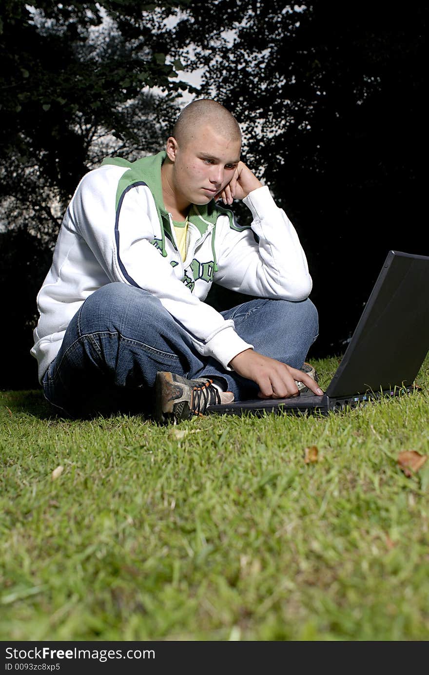 Boy with notebook in park