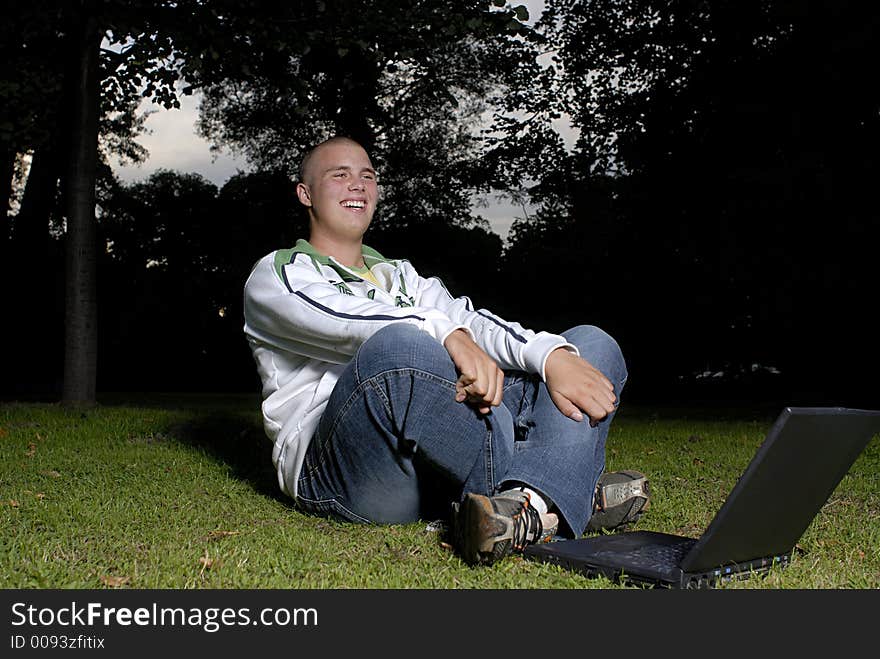 Boy with notebook in park