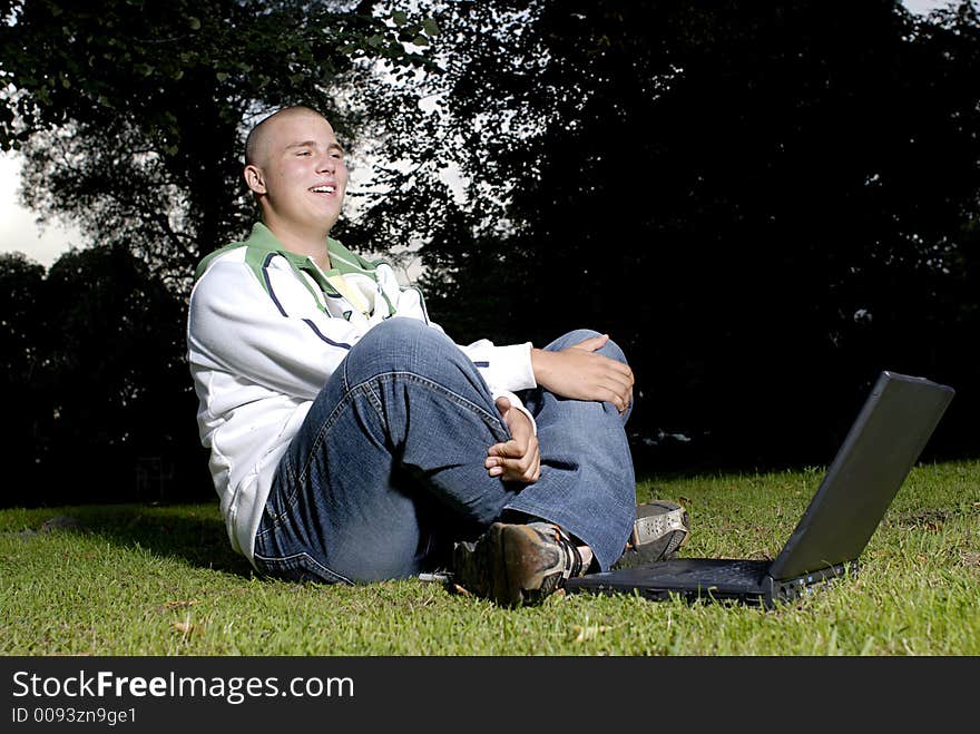 Boy with notebook in park