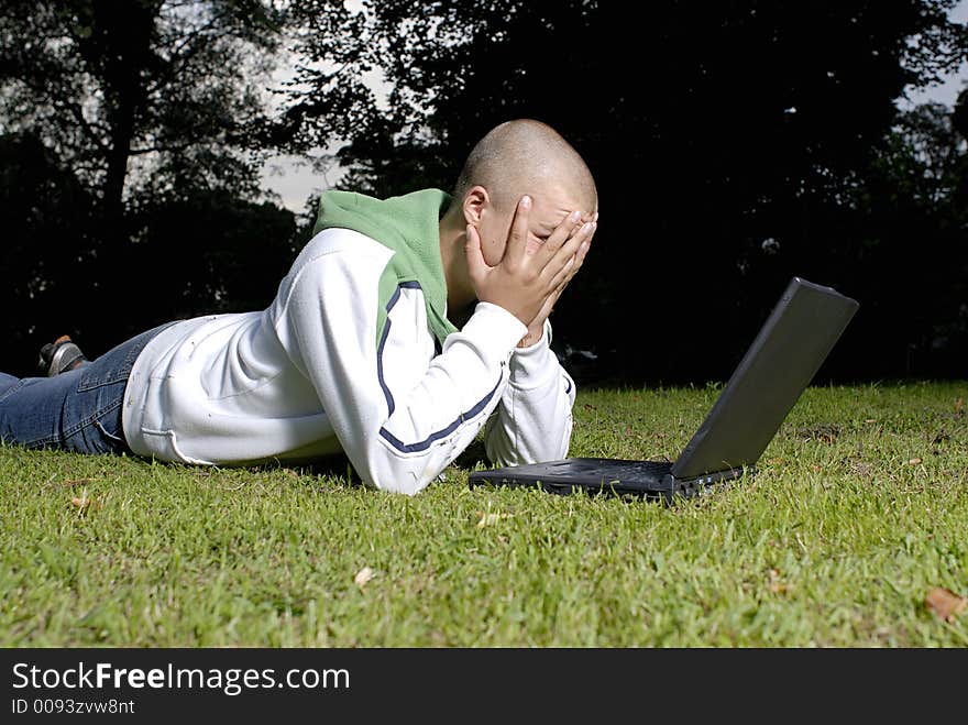 Boy with notebook in park