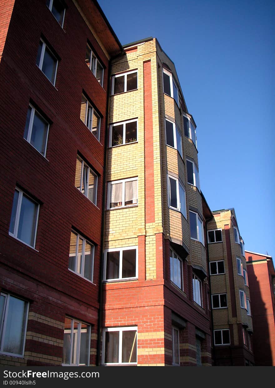 The multiroom brick house on a background of the sky. The multiroom brick house on a background of the sky