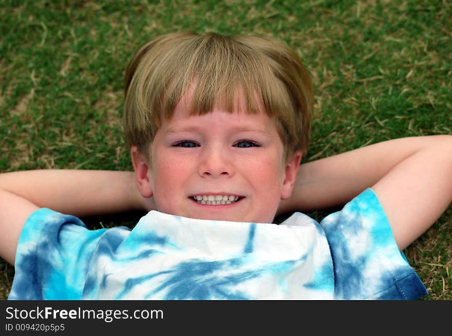 Boy Lying Down In Grass