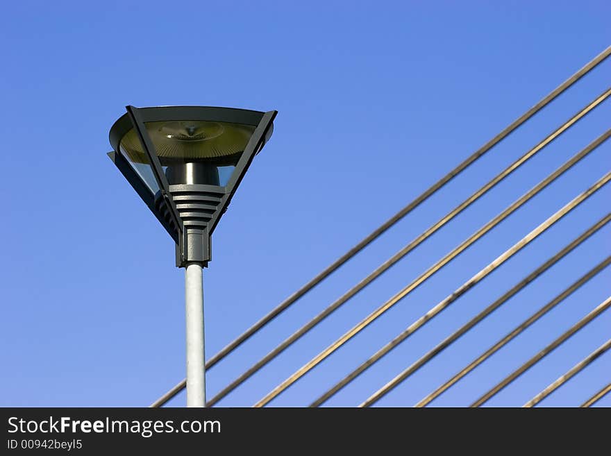 Lamppost and fragment of suspension bridge cables. Lamppost and fragment of suspension bridge cables