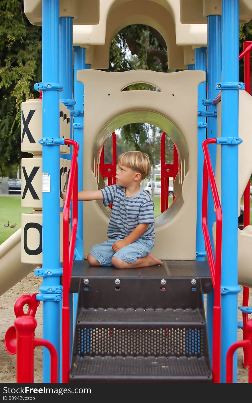 Boy playing tic-tac-toe on play equipment at a park. Boy playing tic-tac-toe on play equipment at a park.