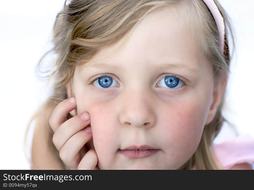 Close up of face of young girl: blue eyes, blonde hair. Close up of face of young girl: blue eyes, blonde hair