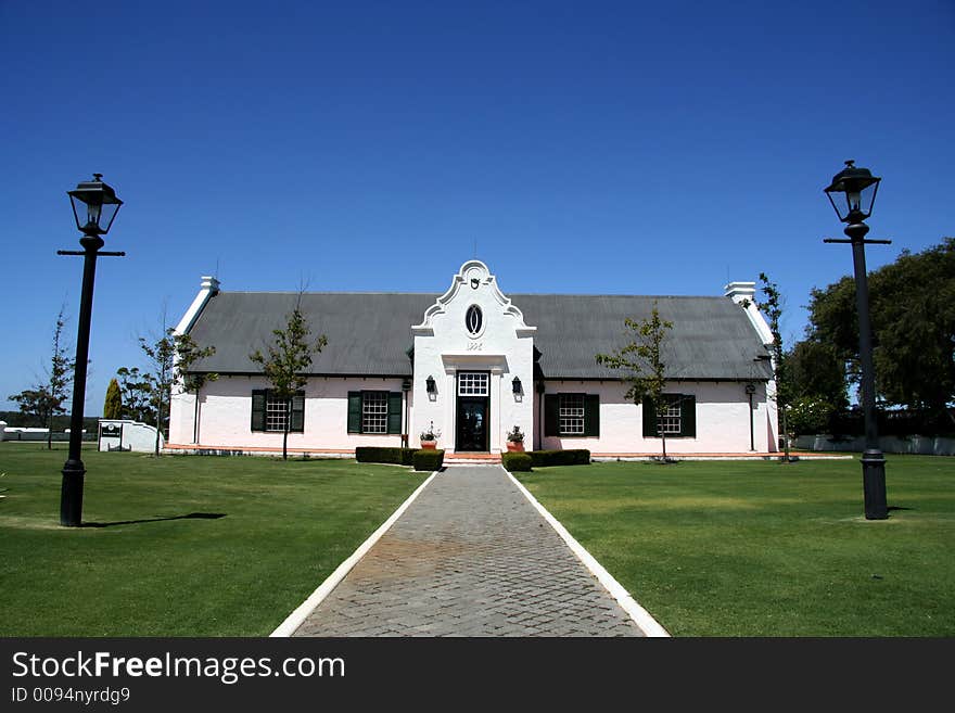 A country cottage with lush green lawn in front