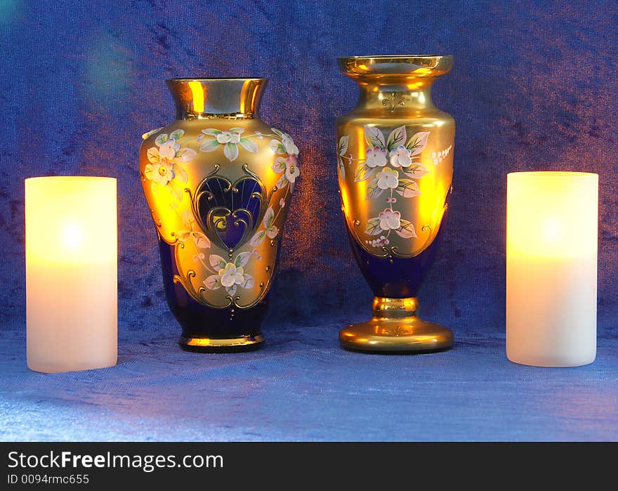 Blue-gold vases, candles, Blue background. Blue-gold vases, candles, Blue background