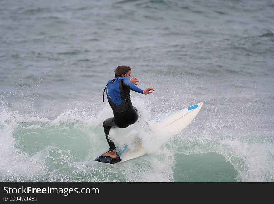 Surfer in the wave with a white board