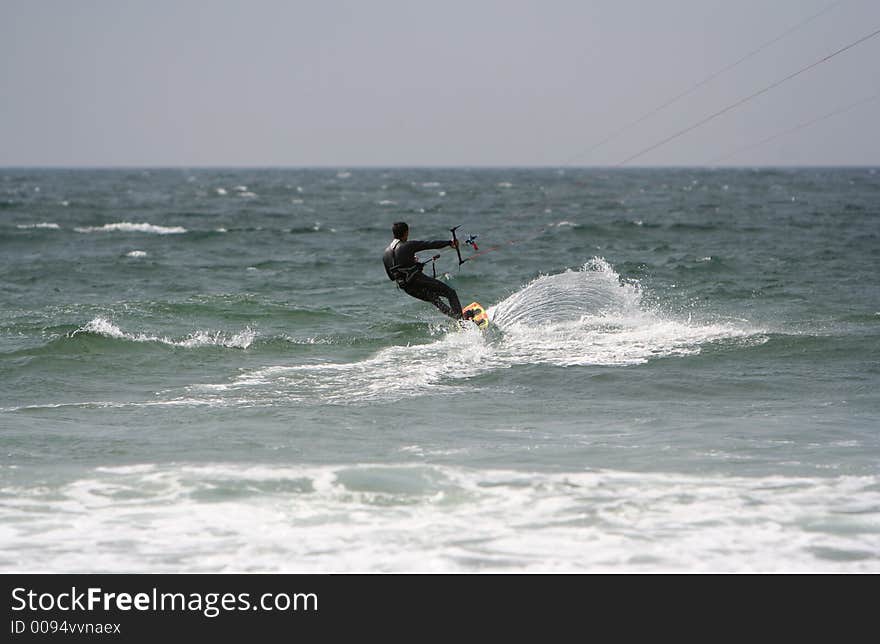 Kitesurfer in the sea with a blue sky