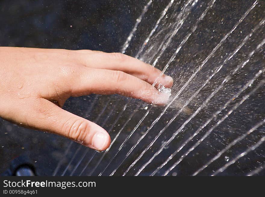 Fun with water, playing with a sprinkler on a hot summer day. Fun with water, playing with a sprinkler on a hot summer day.