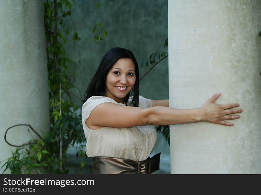 Close up girl holding pillar with a happy face. Close up girl holding pillar with a happy face