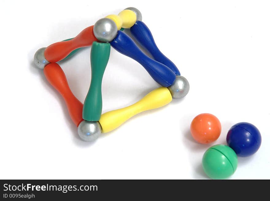 Color balls and a metal ball on white background created a pyramid, isolated. Color balls and a metal ball on white background created a pyramid, isolated