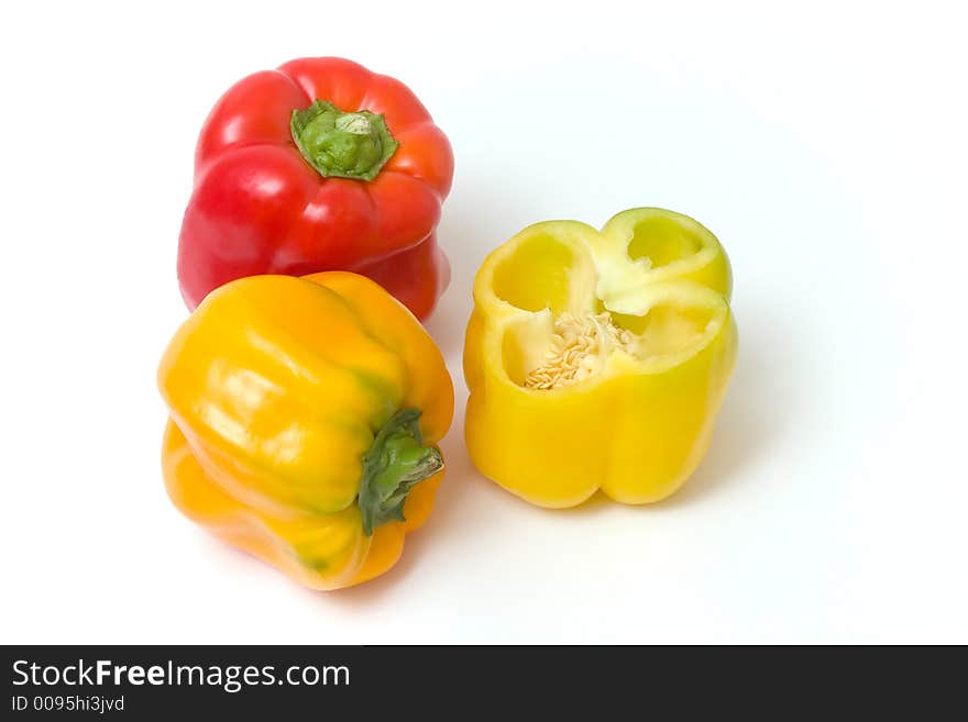 Red and yellow peppers, the yellow one is cut in the middle