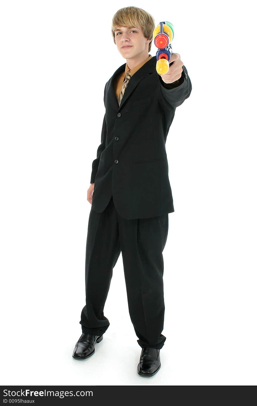 Handsome teen boy in suit with water gun.