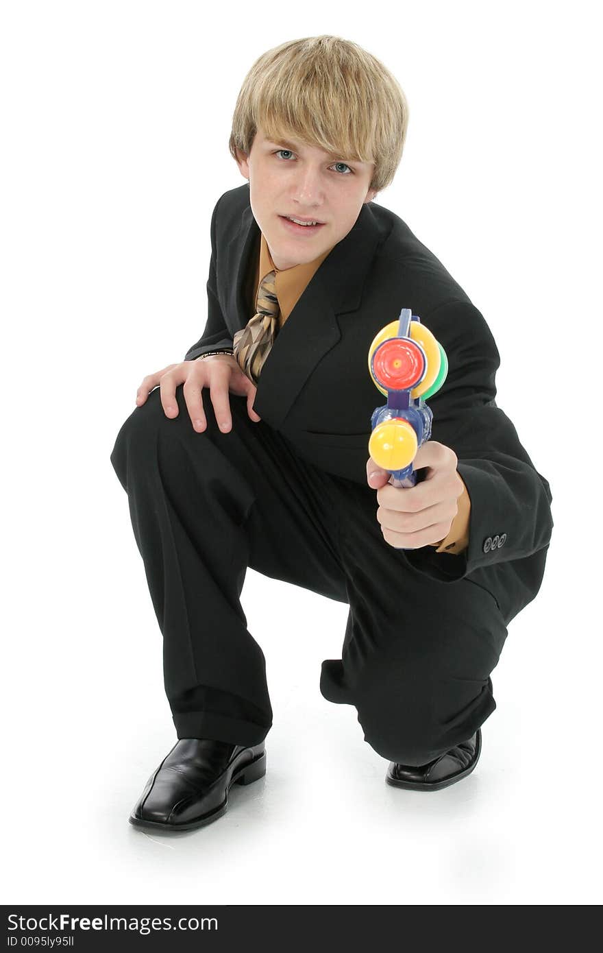 Handsome Teen boy in suit with water gun.