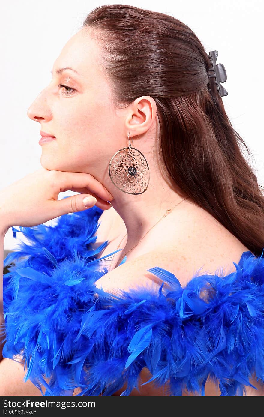 Portrait of a young girl in blue feather