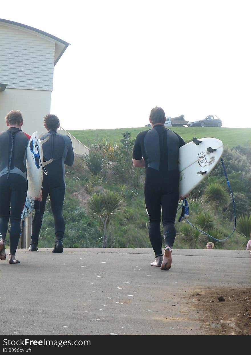 Surfers finish for the day,raglan,new zealand. Surfers finish for the day,raglan,new zealand