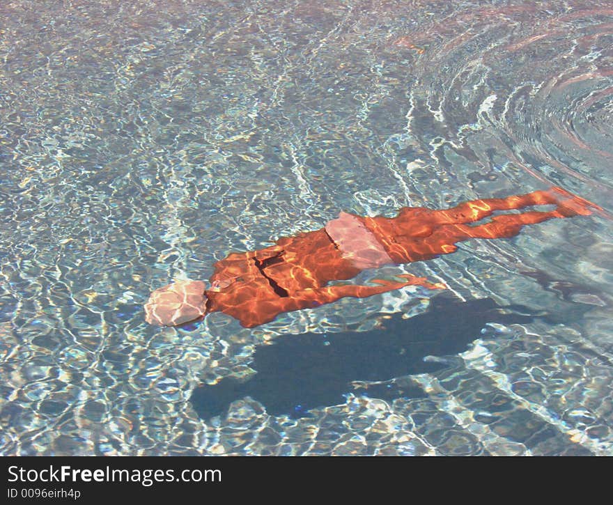 A lone young teen in a swimming pool, isolated from the rest of the world. A lone young teen in a swimming pool, isolated from the rest of the world