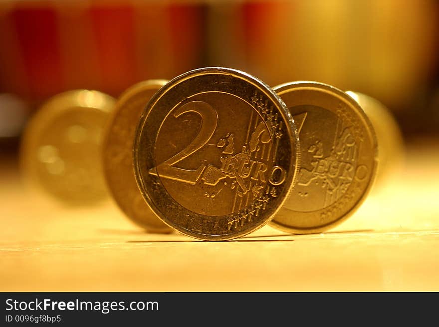 Some golden coins in a yellow light. Some golden coins in a yellow light.