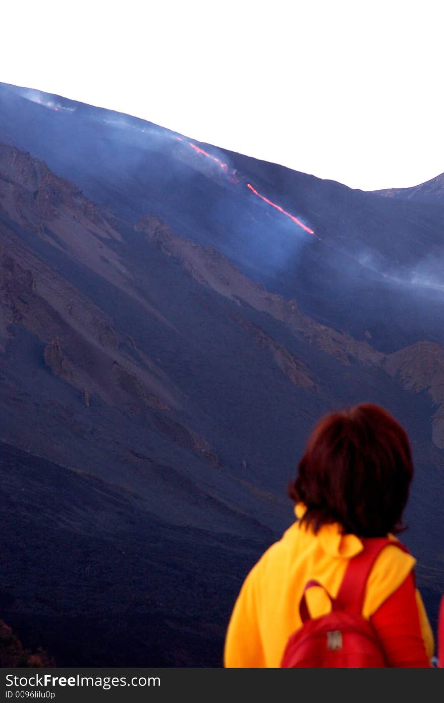 A friend of mine watching fascinated the lavic flow on the Etna vulcan. A friend of mine watching fascinated the lavic flow on the Etna vulcan.