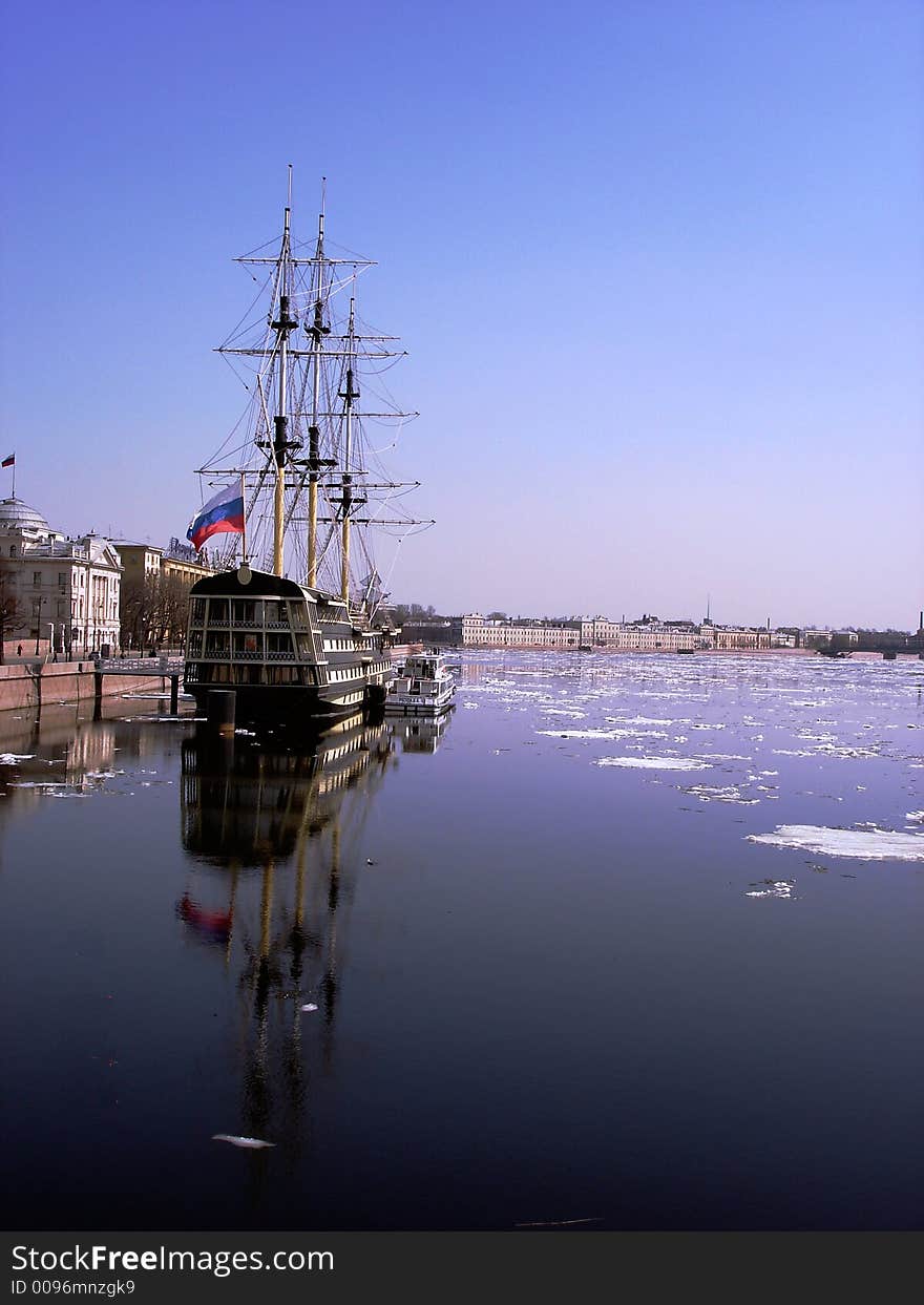 A three-mast ship under clear skies in the icy waters of the Neva river in St Petersburg