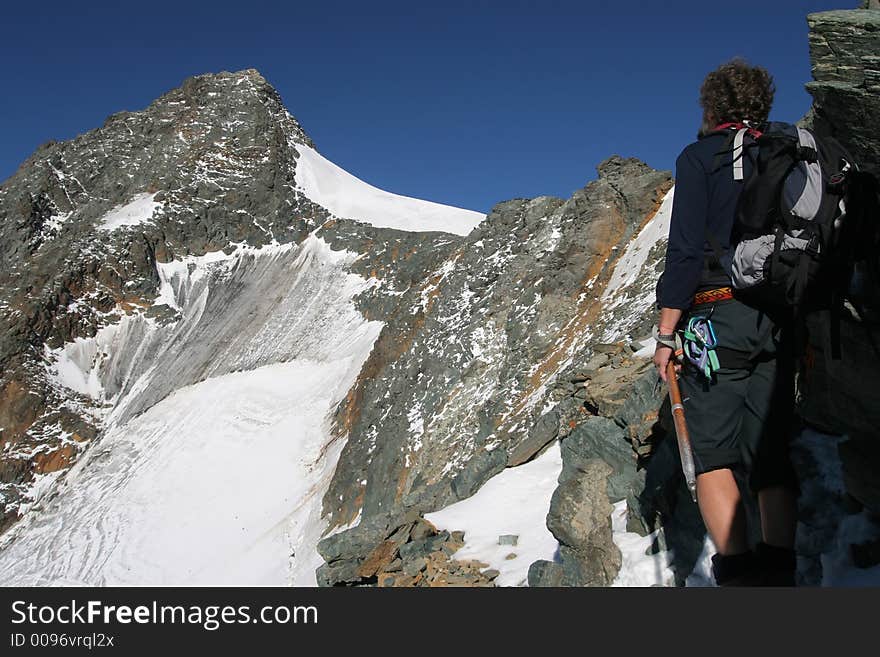 Climber on a mountain ridge in the Alps. Climber on a mountain ridge in the Alps