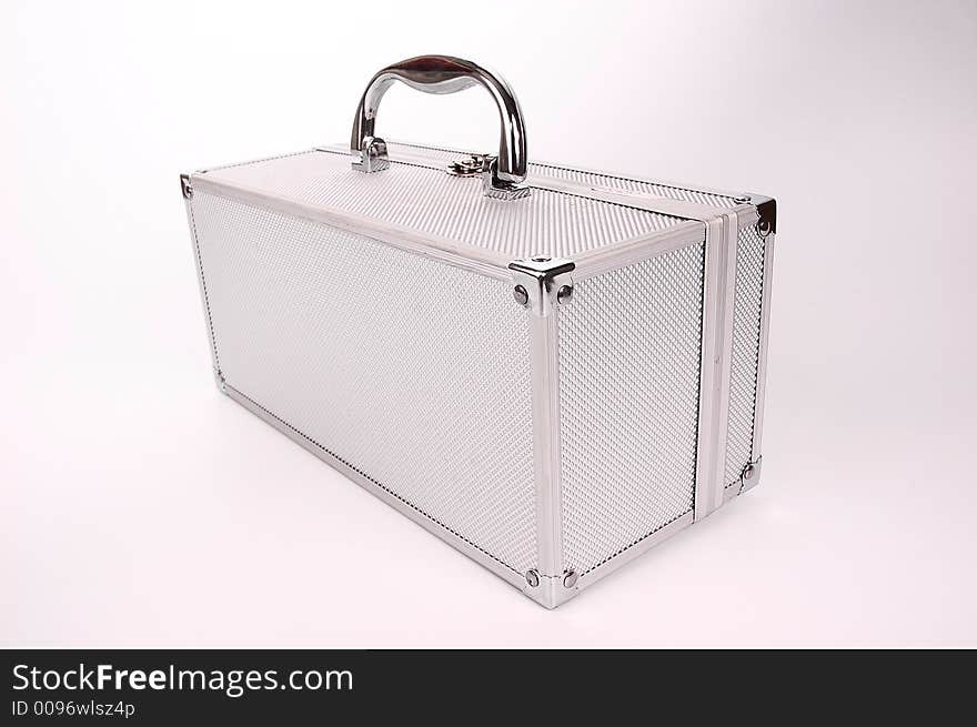 Shining silver case for accessories over white background.