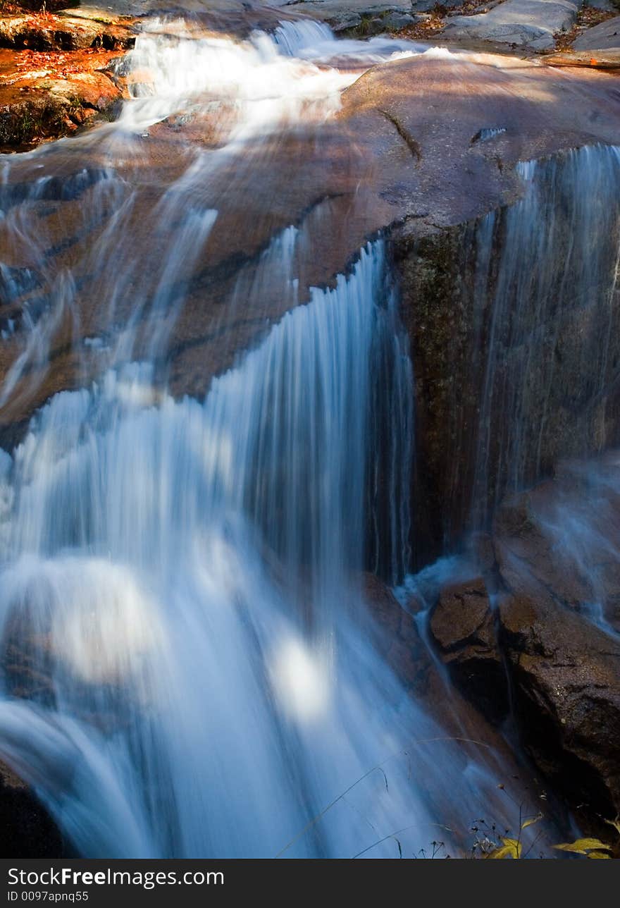 Water falls over boulders at gorge falls. Water falls over boulders at gorge falls.