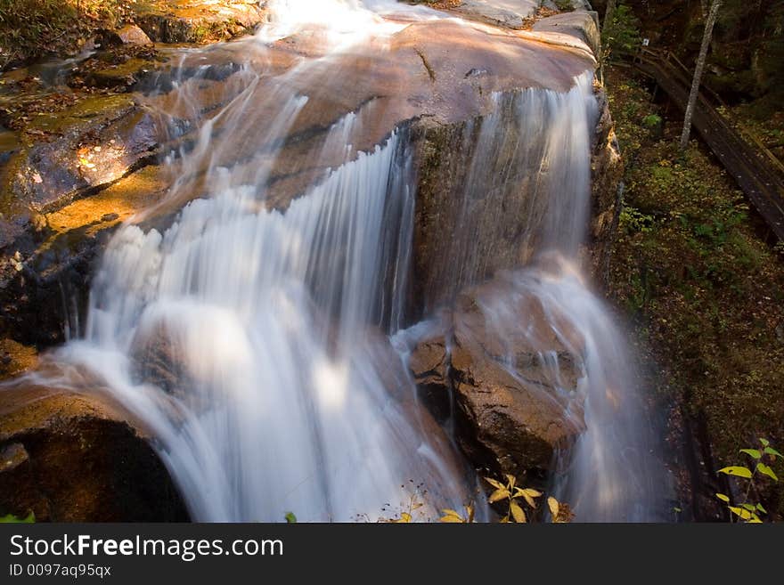 Cool mountain waterfall during the autumn season. Cool mountain waterfall during the autumn season.