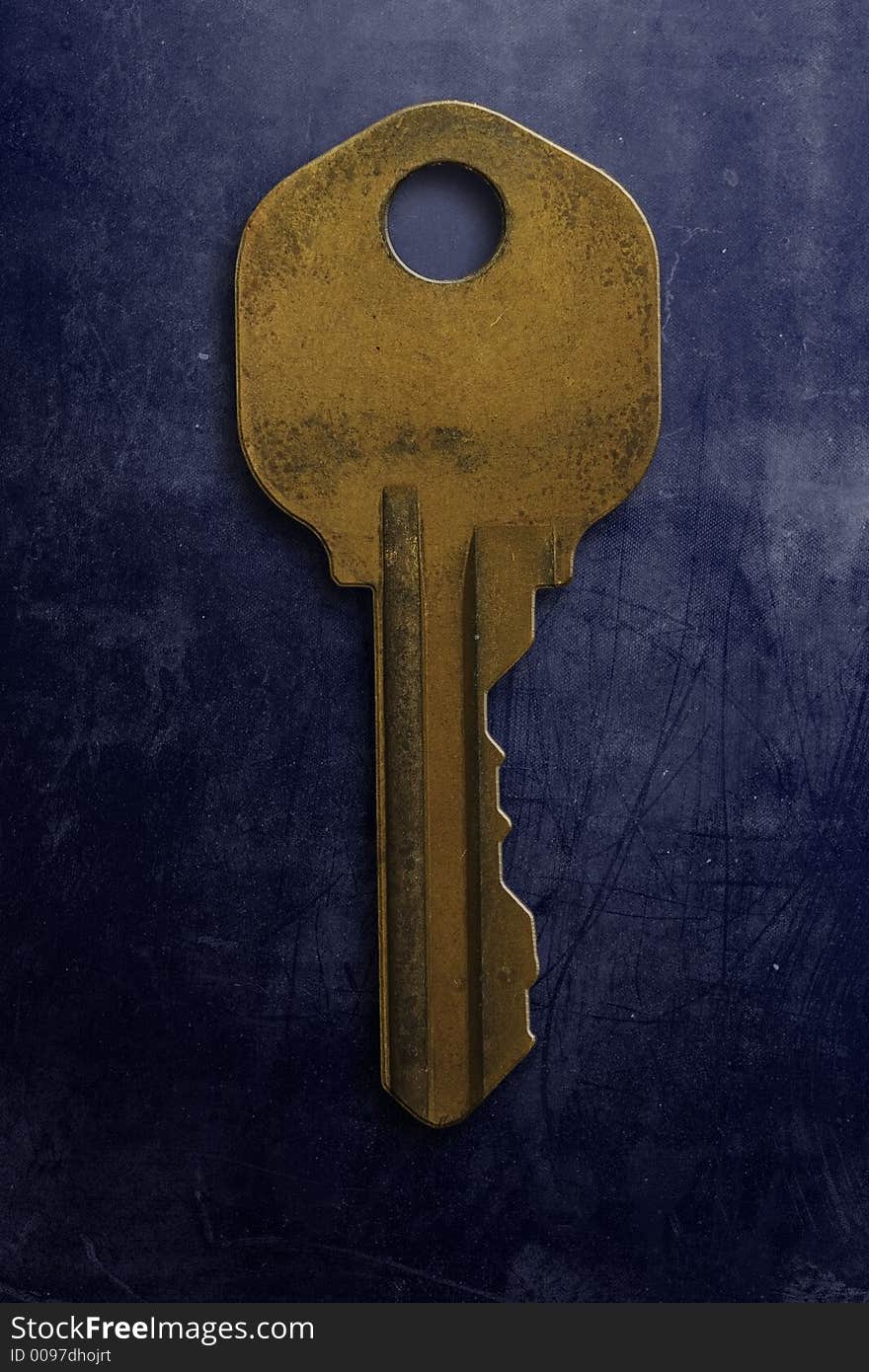 An old rusty key on a grunge textured background. An old rusty key on a grunge textured background