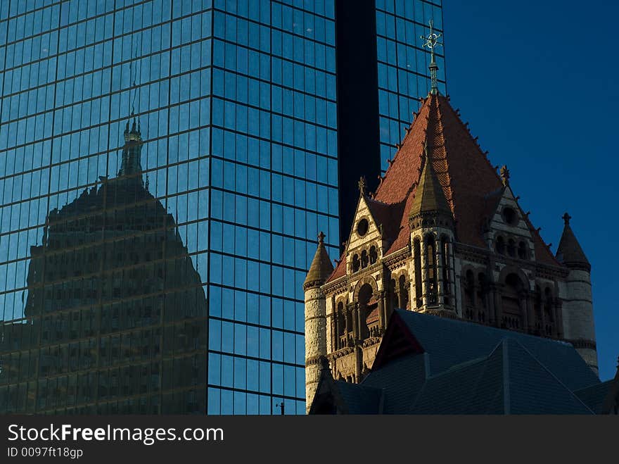 An old building is mirrored by another in a modern skyscraper. An old building is mirrored by another in a modern skyscraper.