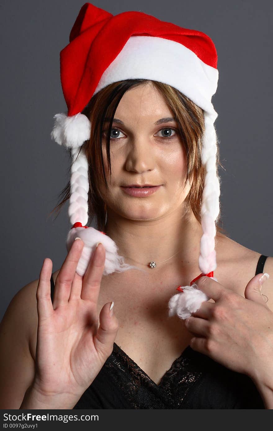 Young santa girl in front of grey background. Young santa girl in front of grey background