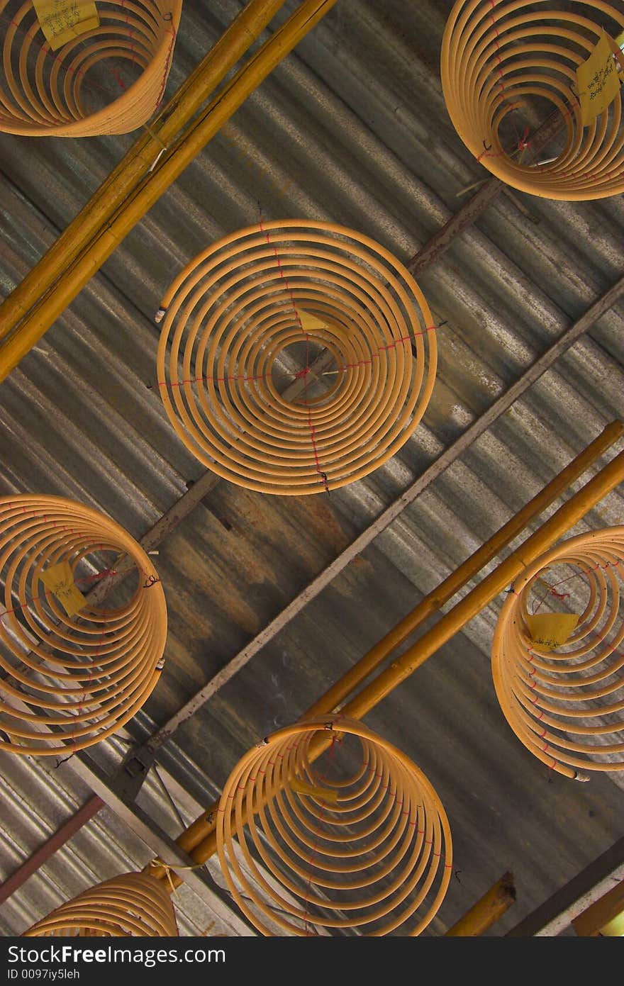 Hanging circular joss-sticks against dark background. Hanging circular joss-sticks against dark background