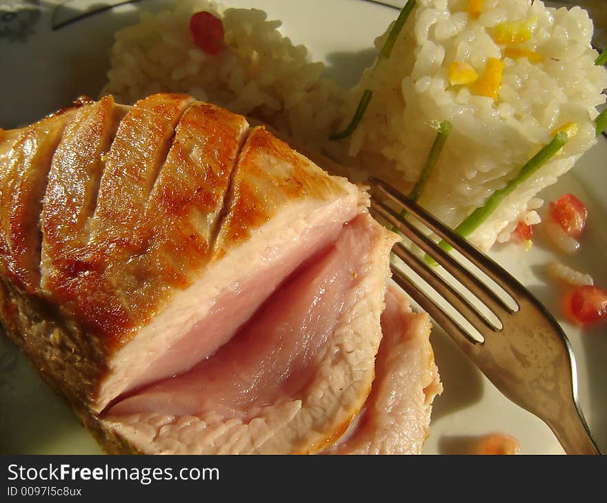 Roast pork served with risotto garnish and decorated with apple and lettuce. Roast pork served with risotto garnish and decorated with apple and lettuce