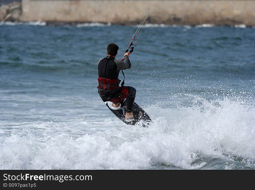 Kitesurfer jumping in the sea