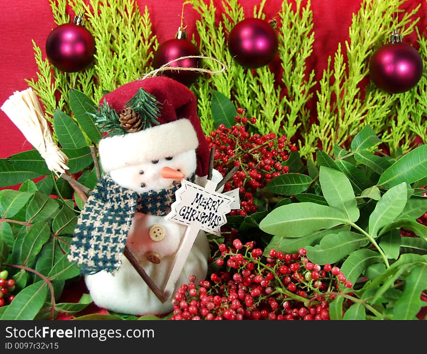 A funny snowman whit tree leaves decoration and christmas balls