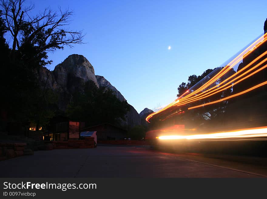 A bus turn in as the sun goes down and moon goes up in zion canyon national park. A bus turn in as the sun goes down and moon goes up in zion canyon national park