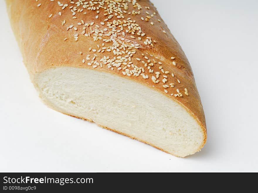 Close up of cut end of a loaf of French bread with sesame seed topping. Close up of cut end of a loaf of French bread with sesame seed topping