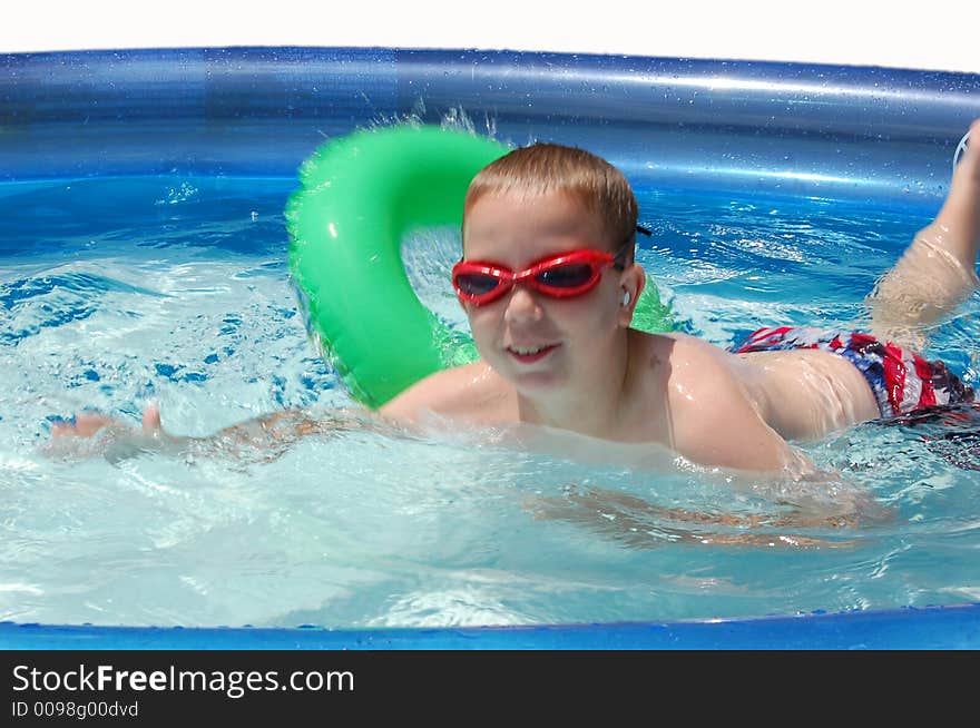 Child playing in the swimming pool. Child playing in the swimming pool